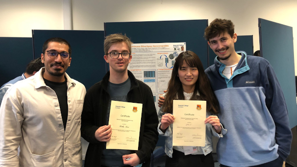 Charlie Shaw with three other students showing off his poster prize award